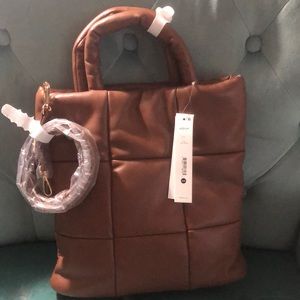 Handbag can also be worn as a crossbody bag. Brown/Cognac in color.